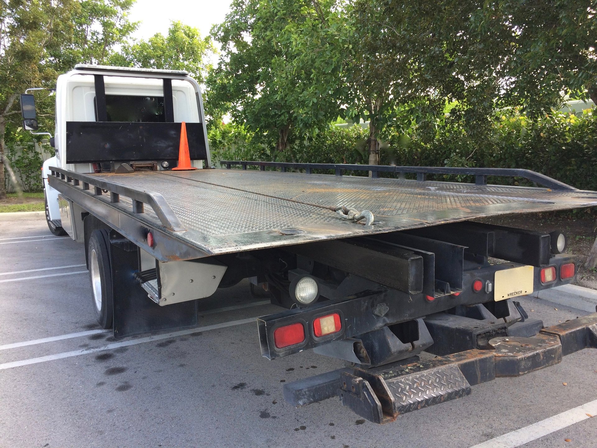 Flatbed wrecker in parking lot
